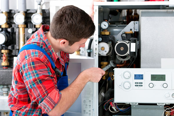 Heating technician repairing boiler controls in Sunnyvale