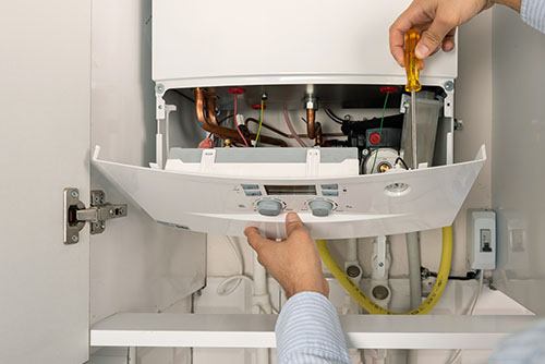 Heating technician repairing a residential boiler in Sunnyvale