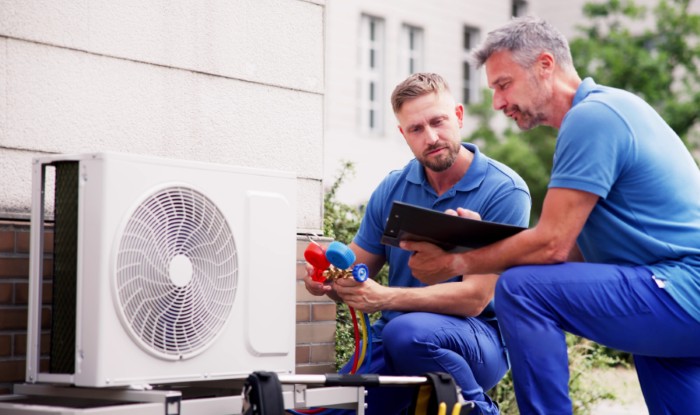HVAC technicians installing an outdoor air conditioning unit in Sunnyvale