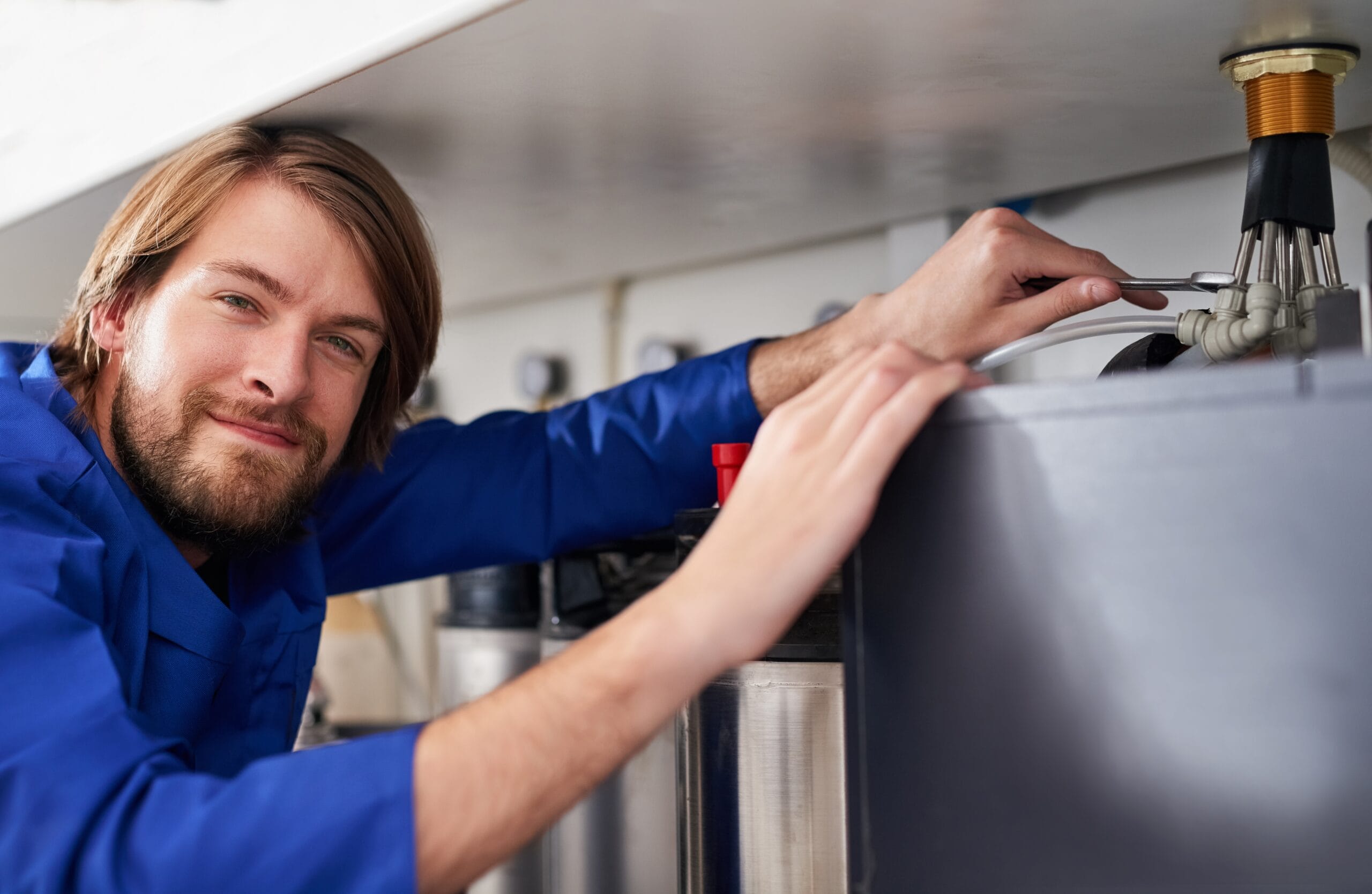 Technician servicing a residential water heater tank in Sunnyvale